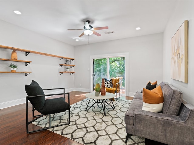 living room featuring ceiling fan and dark hardwood / wood-style floors