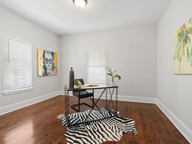 office area featuring plenty of natural light and dark hardwood / wood-style flooring