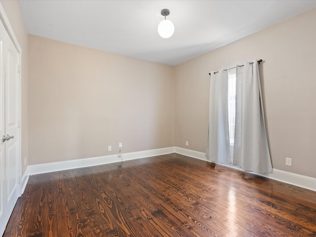 spare room featuring dark hardwood / wood-style flooring