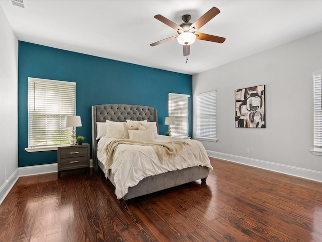 bedroom with dark hardwood / wood-style floors and ceiling fan