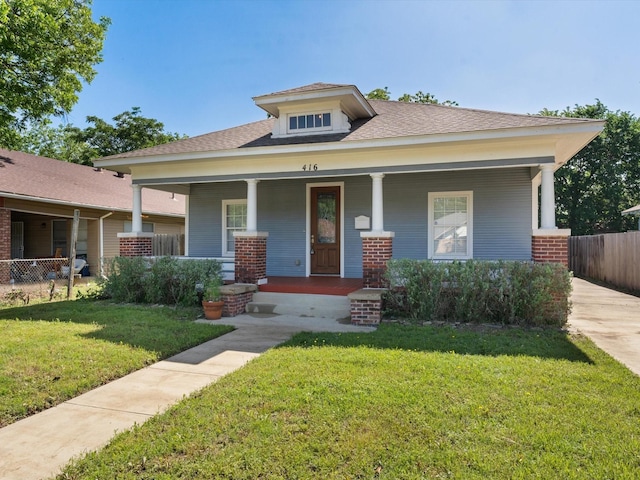 view of front of house featuring a front yard and covered porch