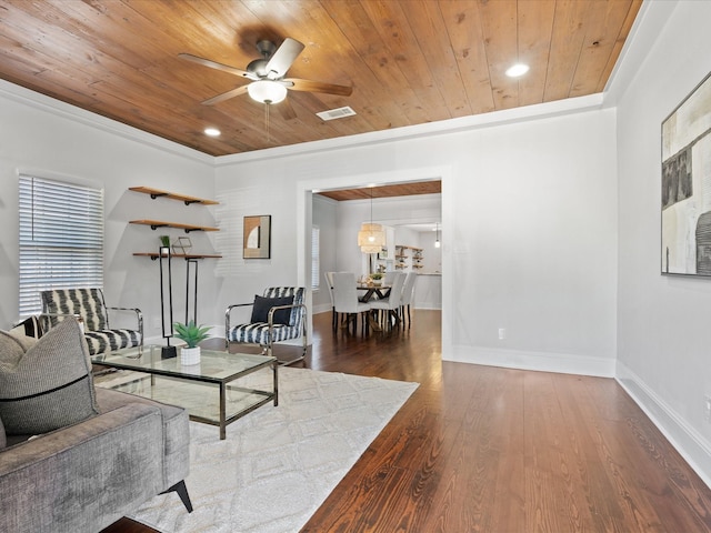 living room featuring wood-type flooring, ornamental molding, ceiling fan, plenty of natural light, and wooden ceiling