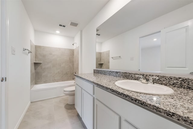 full bathroom with tile patterned floors, toilet, vanity, and tiled shower / bath combo