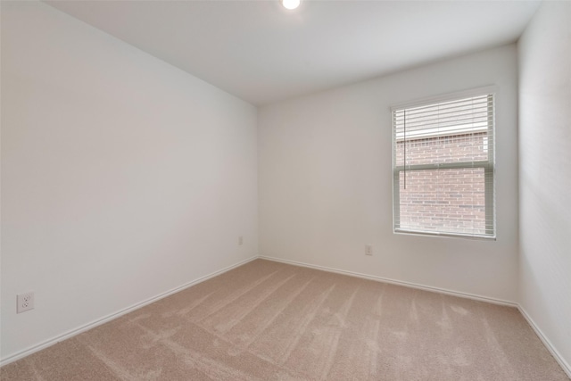 spare room with light colored carpet