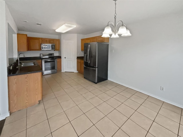 kitchen with pendant lighting, sink, stainless steel appliances, a notable chandelier, and light tile patterned flooring