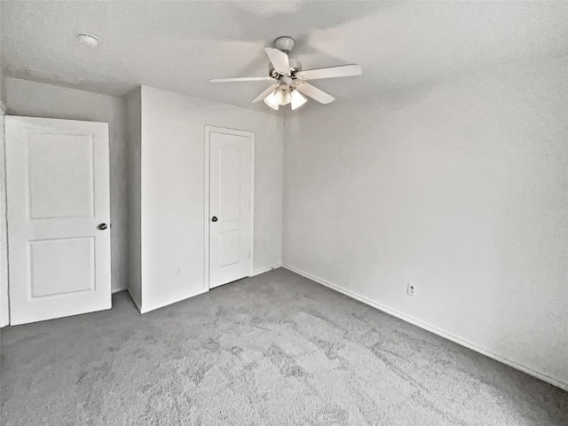 unfurnished bedroom with ceiling fan and carpet flooring