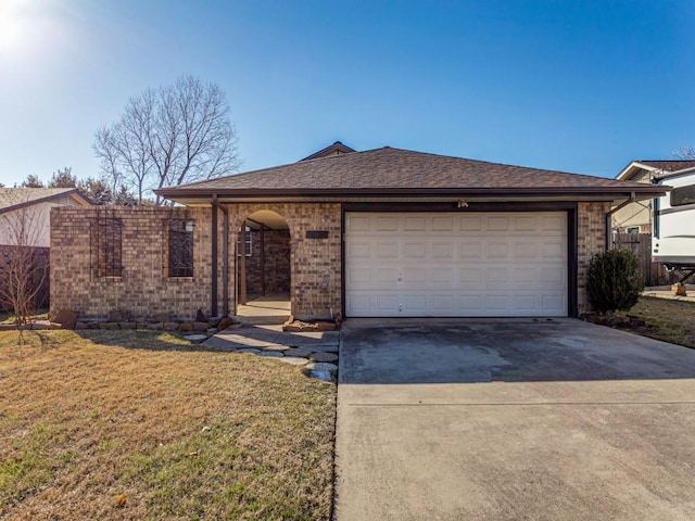 single story home featuring a garage and a front yard