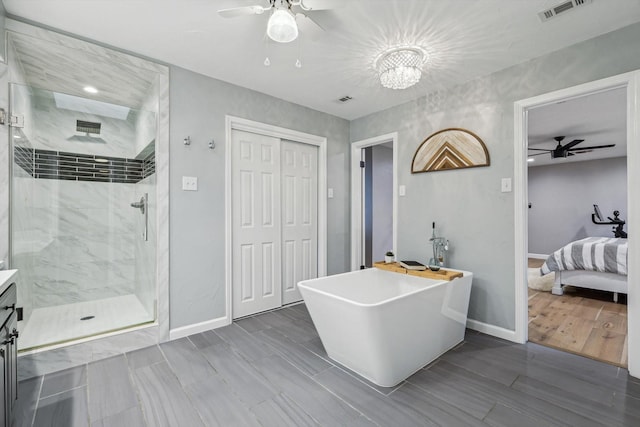 bathroom with vanity, shower with separate bathtub, and ceiling fan