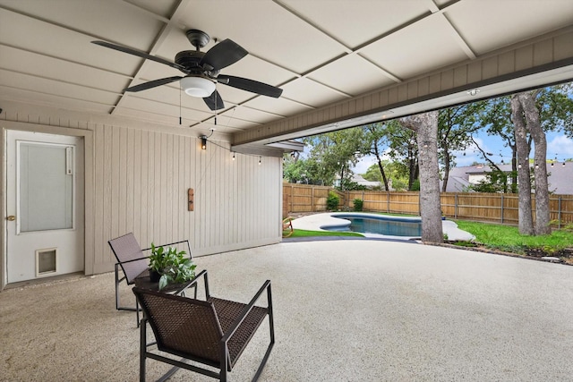 view of patio / terrace with a fenced in pool and ceiling fan