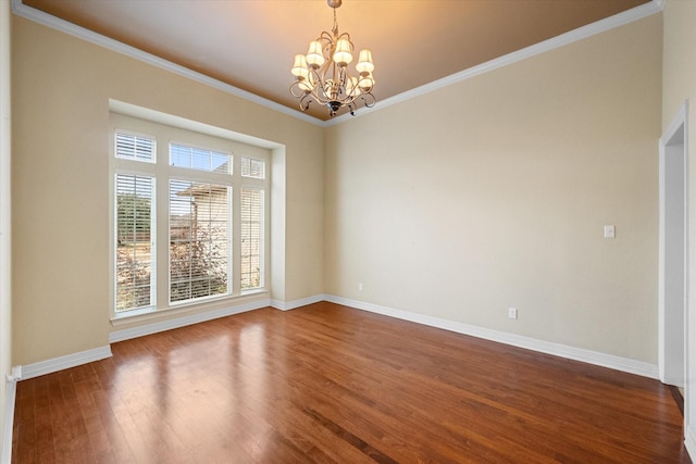 empty room featuring baseboards, dark wood-type flooring, an inviting chandelier, and ornamental molding