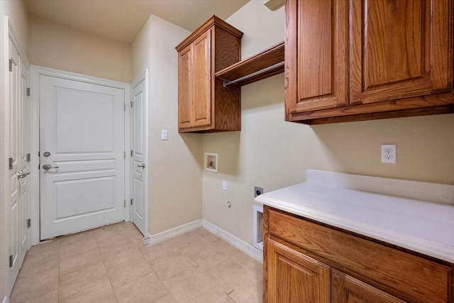 laundry area with electric dryer hookup, hookup for a gas dryer, cabinet space, baseboards, and hookup for a washing machine