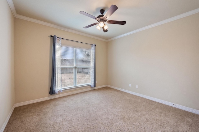 carpeted empty room with crown molding, baseboards, and ceiling fan