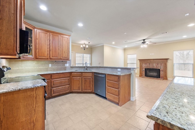 kitchen featuring brown cabinetry, a peninsula, a sink, dishwasher, and open floor plan