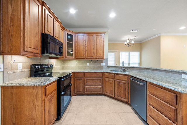 kitchen with a sink, visible vents, black appliances, and brown cabinetry