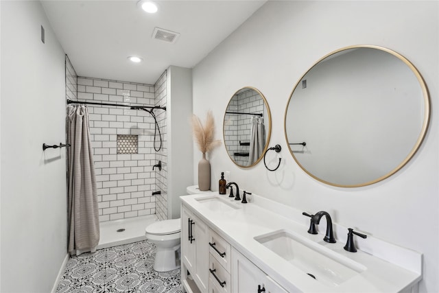 bathroom with toilet, vanity, tile patterned floors, and a shower with curtain