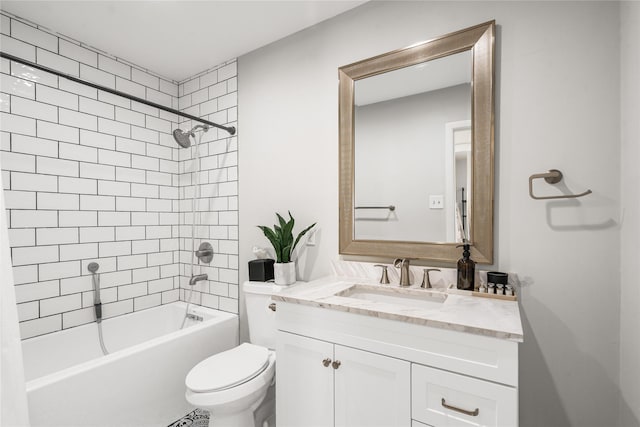 full bathroom featuring vanity, tiled shower / bath combo, and toilet