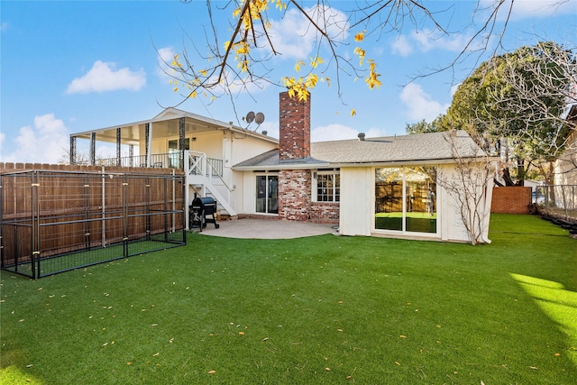 back of house with a yard and a patio area