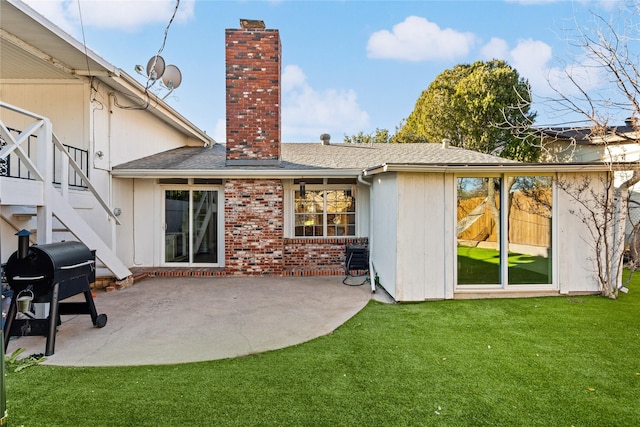 rear view of house with a patio and a lawn