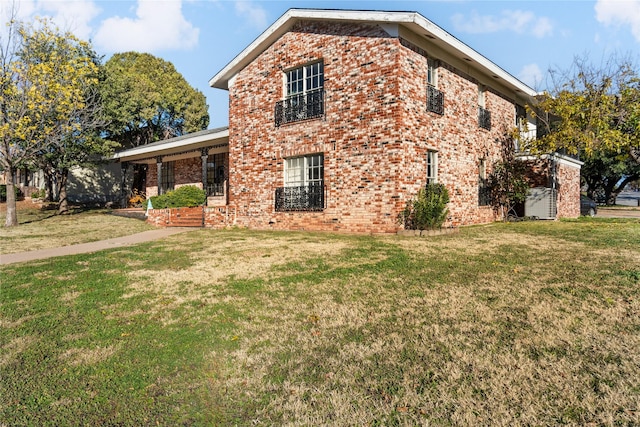 view of side of property with a lawn