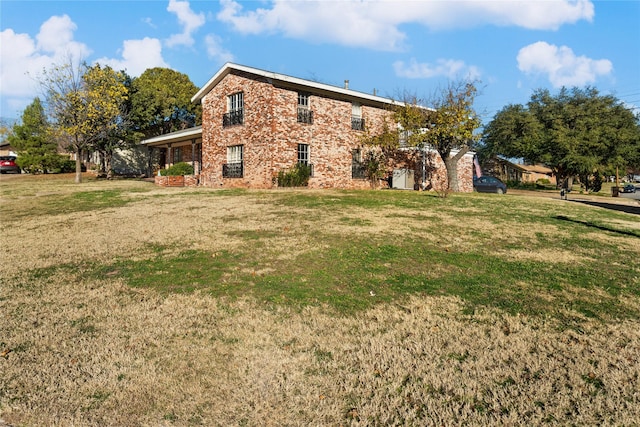 rear view of property featuring a lawn