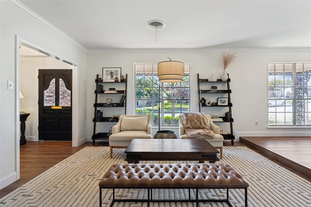 sitting room featuring hardwood / wood-style floors, crown molding, and a wealth of natural light