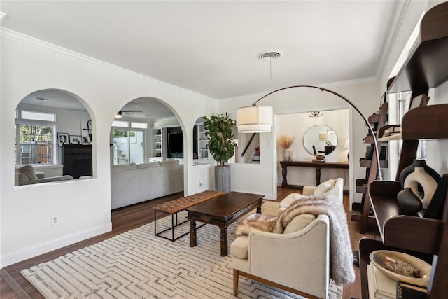 living room with ornamental molding and dark hardwood / wood-style floors