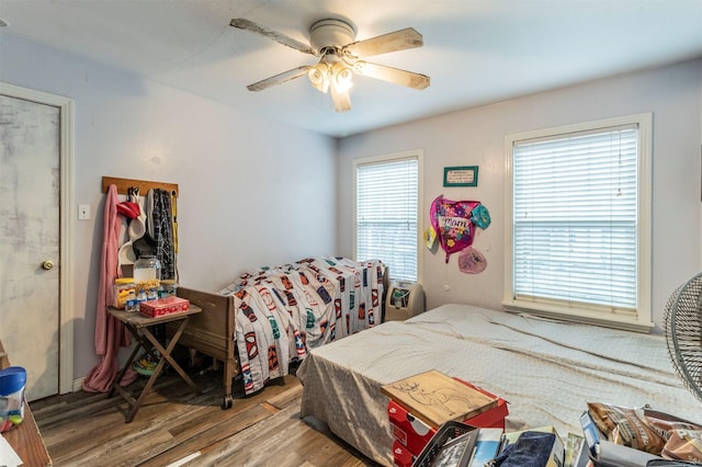 bedroom with ceiling fan and wood finished floors