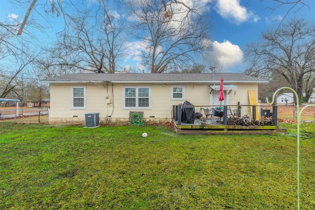 back of property featuring cooling unit, a lawn, fence, and crawl space