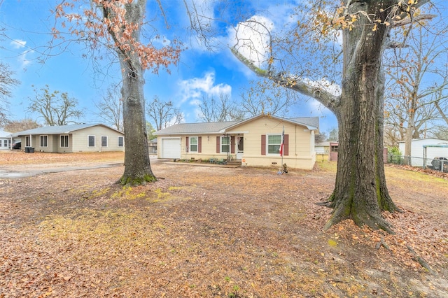 view of front of home with fence and a garage