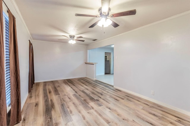 unfurnished room with crown molding, wood finished floors, baseboards, and ceiling fan