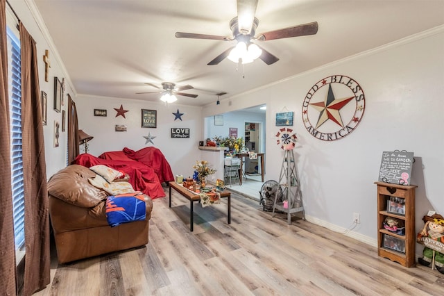 living room with light wood-type flooring, ceiling fan, and ornamental molding