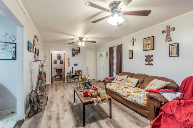 living area with light wood finished floors, a ceiling fan, and ornamental molding