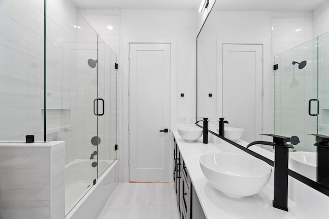 bathroom with bath / shower combo with glass door and vanity