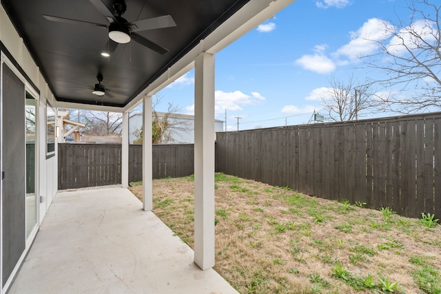 view of yard featuring ceiling fan and a patio area