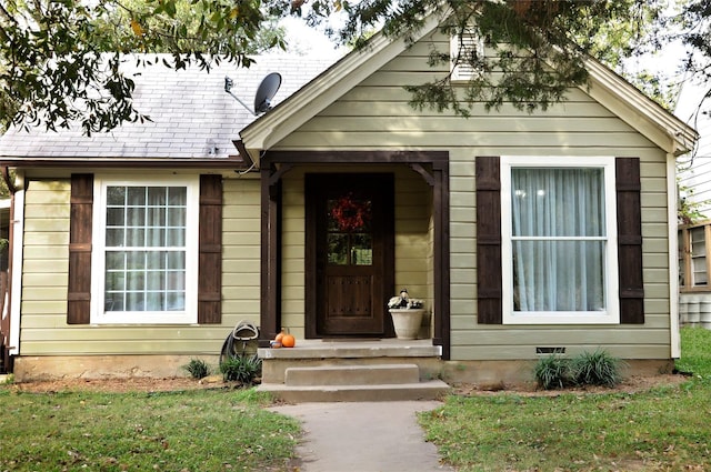 doorway to property featuring a yard