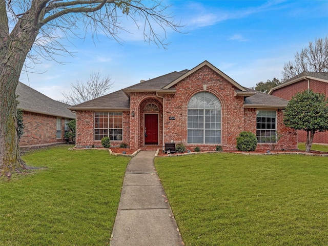 ranch-style home featuring a front yard