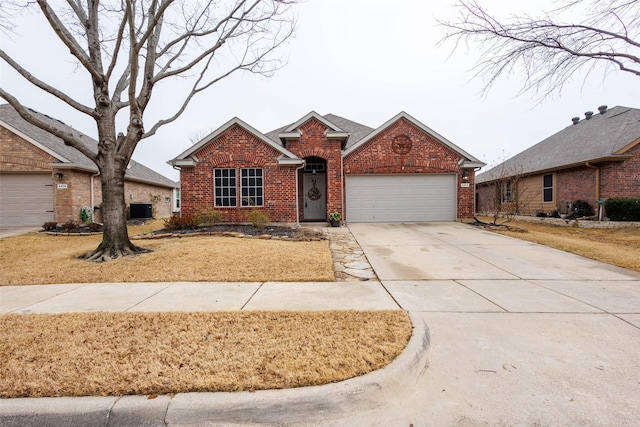 view of front of house featuring a garage and central AC