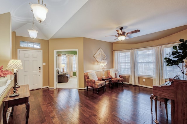 foyer entrance with dark wood-type flooring, ceiling fan, and vaulted ceiling