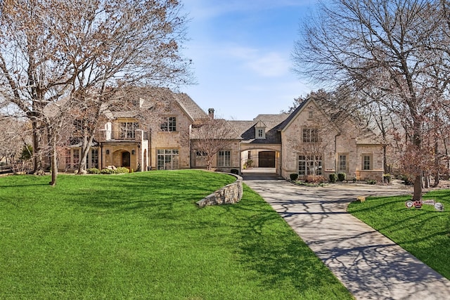 tudor-style house with a front lawn