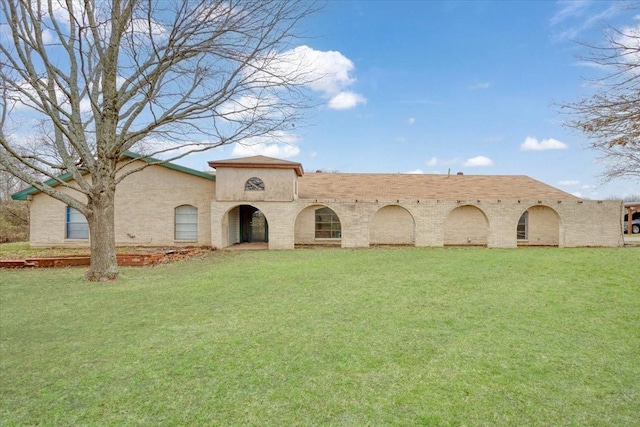 mediterranean / spanish house with a front lawn