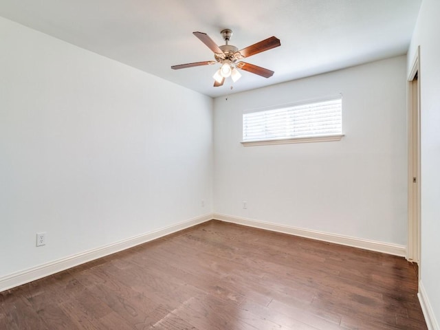 empty room with dark wood-type flooring and ceiling fan