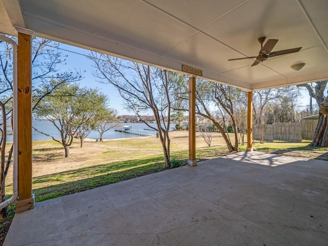 view of patio with a water view and ceiling fan