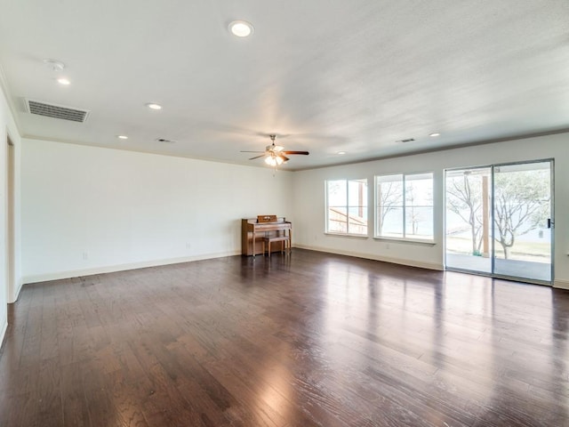 unfurnished room featuring dark wood-type flooring and ceiling fan