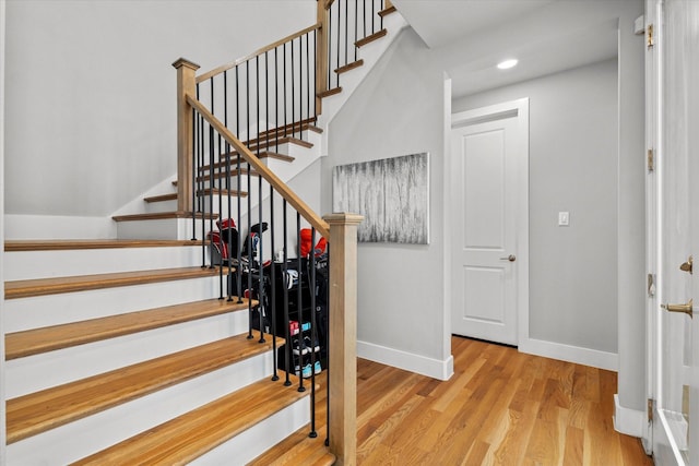 stairway with hardwood / wood-style floors