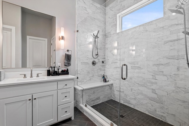 bathroom featuring walk in shower, vanity, and tile patterned flooring