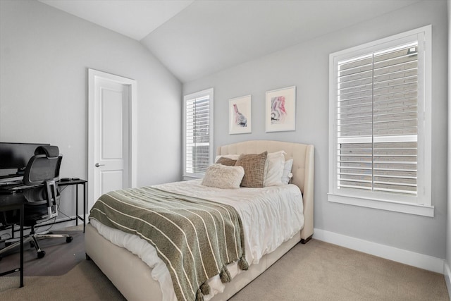 bedroom with lofted ceiling and carpet floors