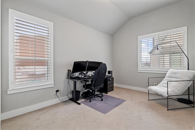 carpeted home office featuring lofted ceiling