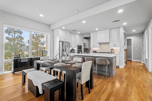 dining space with light hardwood / wood-style flooring