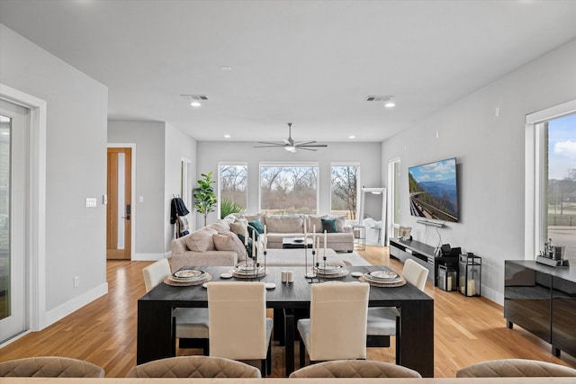 dining room featuring ceiling fan, light wood-type flooring, and a wealth of natural light