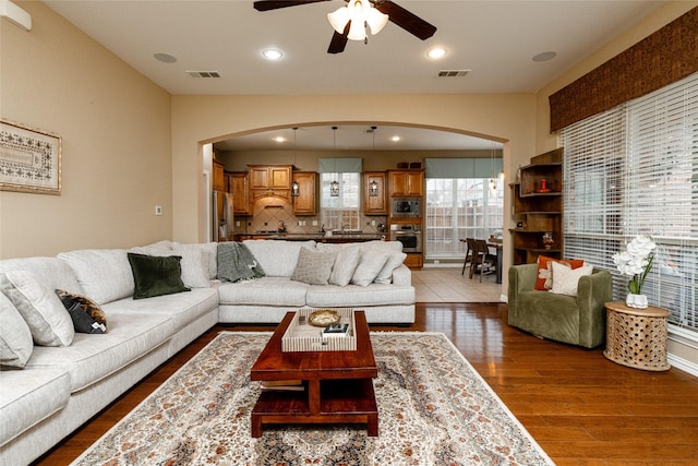 living room featuring vaulted ceiling, hardwood / wood-style floors, and ceiling fan